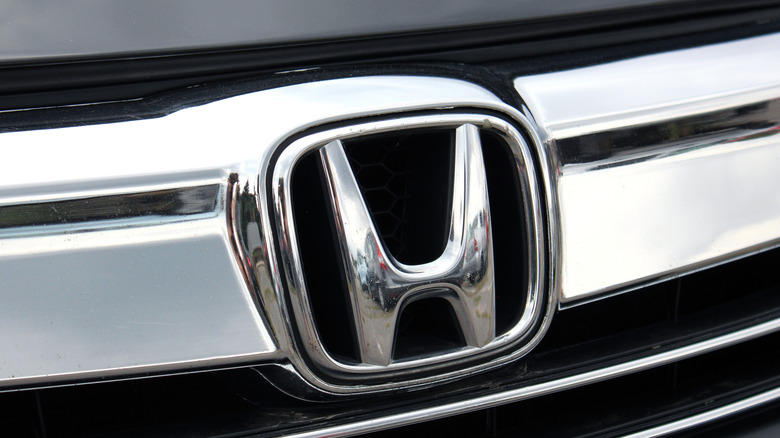 Close-up of Honda logo on black car