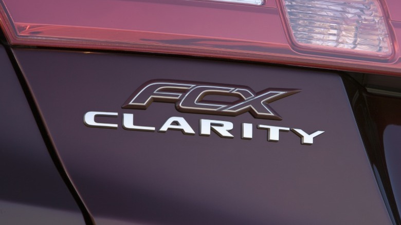 Close-up of Honda FCX Clarity badge on a maroon car