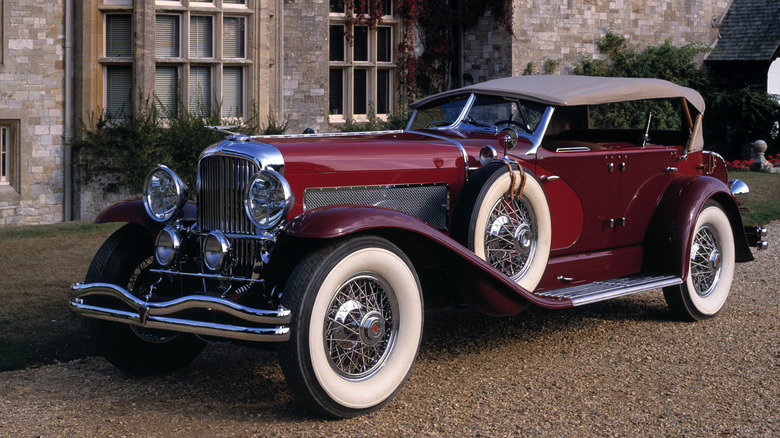 Duesenberg Model J parked outside a house