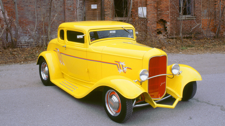 1932 Ford Model 18 parked outside a brick building