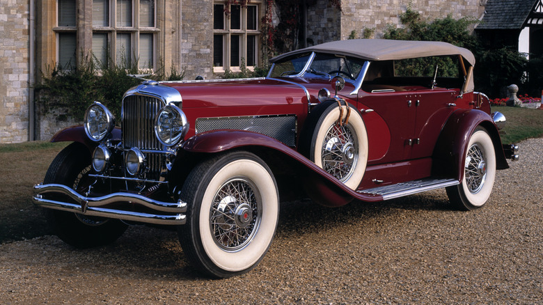 Duesenberg Model J parked outside a house