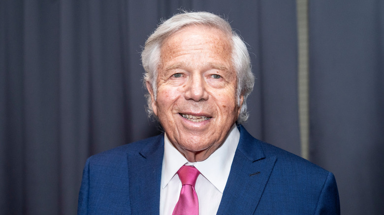 Robert Kraft in a blue suit and a maroon tie
