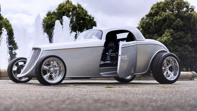 Silver hot rod with open suicide door