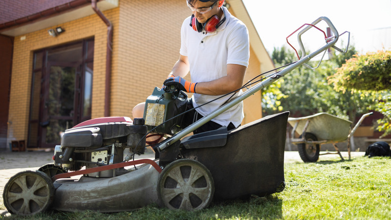 pouring fuel into a lawn mower