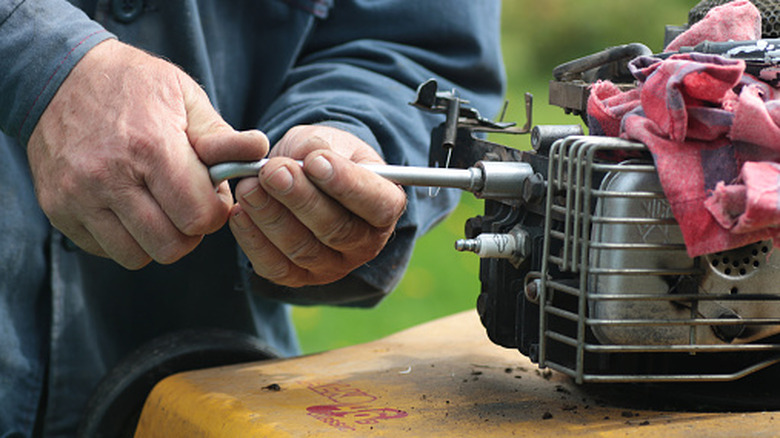 performing maintenance on a lawn mower engine