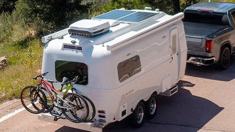 Rear and side of an Oliver Travel Trailer pulled behind a truck