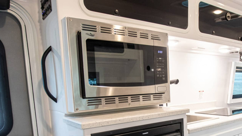 Closeup of the microwave air fryer in an Oliver Apex X23 trailer