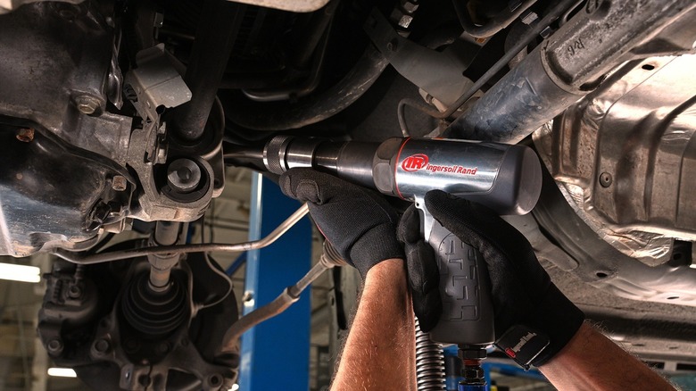 person using air hammer in shop