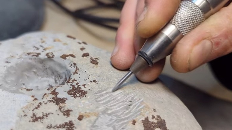 Air scribe carving rock