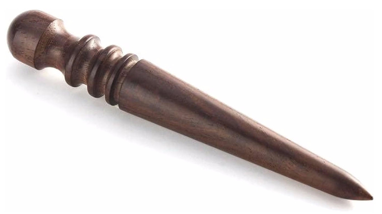 Wooden burnisher on it side displaying its grooves