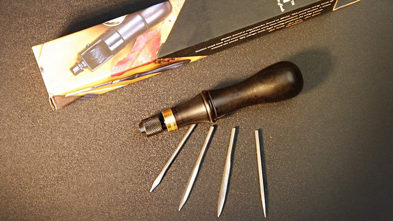 Owden Awl set with all of the blades out sitting next to the handle