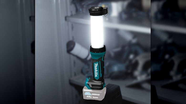 Makita flashlight offering 360-degree illumination in a garage.