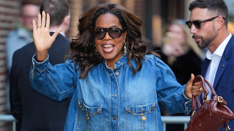 Oprah Winfrey on the street with her fans and security