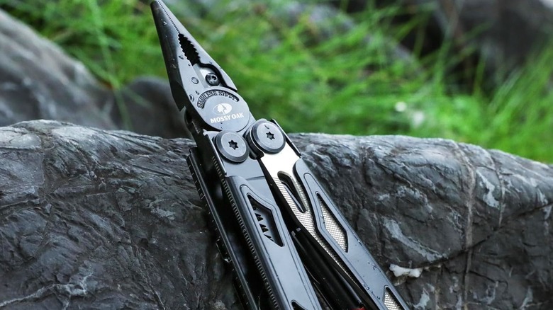 A multitool leaning on a rock.