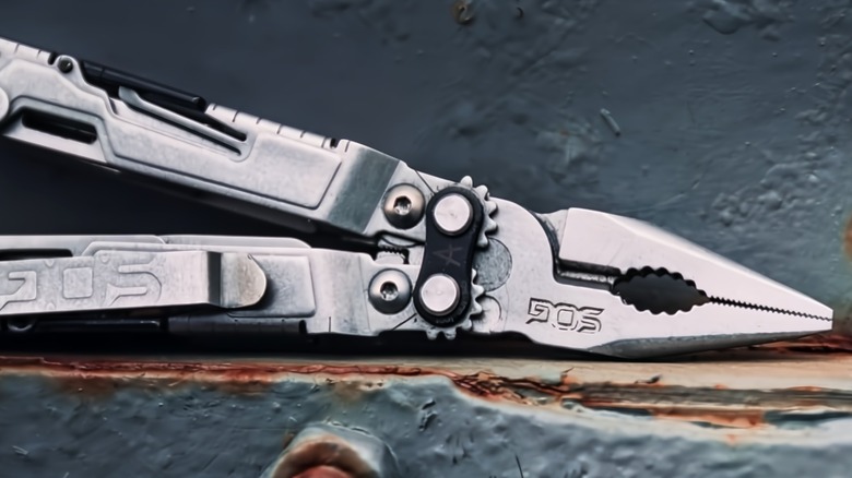 A multitool left on a rusty area.
