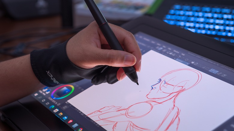 man drawing on a tablet