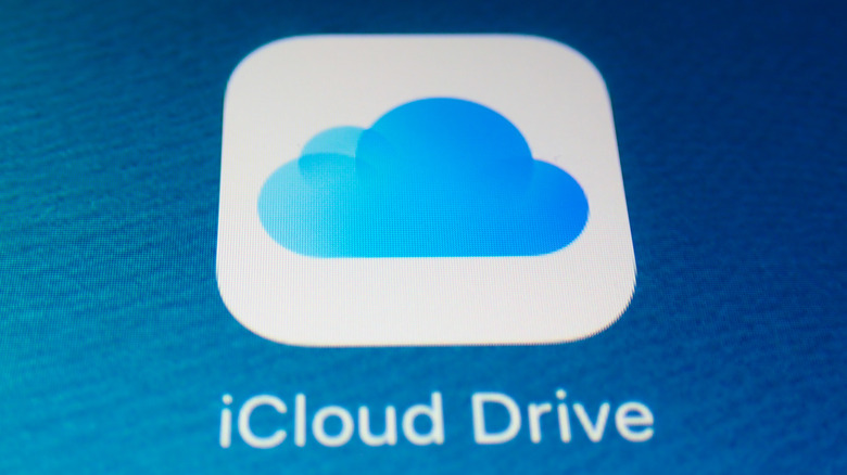 Close-up image of iCloud Drive logo against a blue background on a screen
