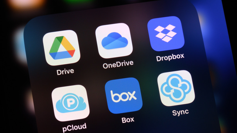 Smartphone screen displaying logos of Google Drive, Microsoft OneDrive, DropBox, pCloud, Box, and Sync