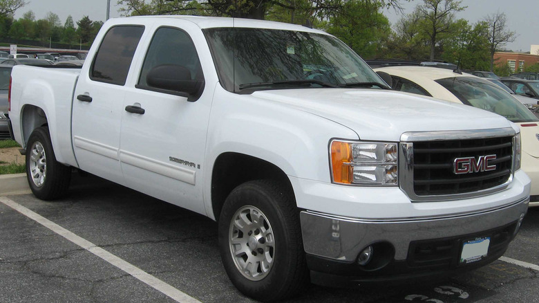 A white 2007 GMC Seirra crew cab parked in a spot