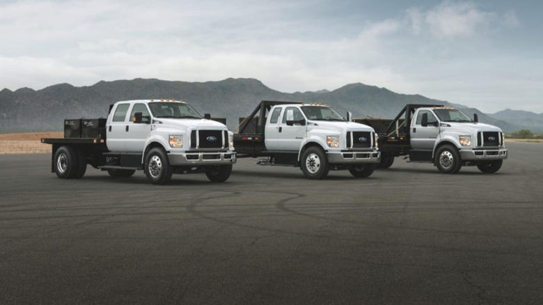 A trio of Ford F-650 trucks on a paved road