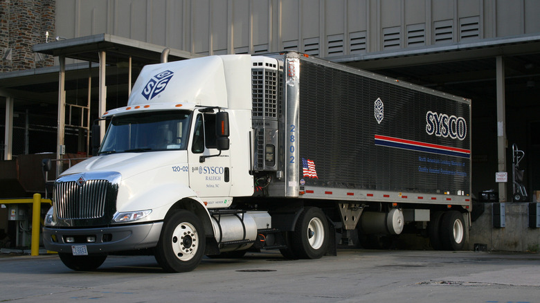An Interntional 8000 semi truck being loaded at a dock