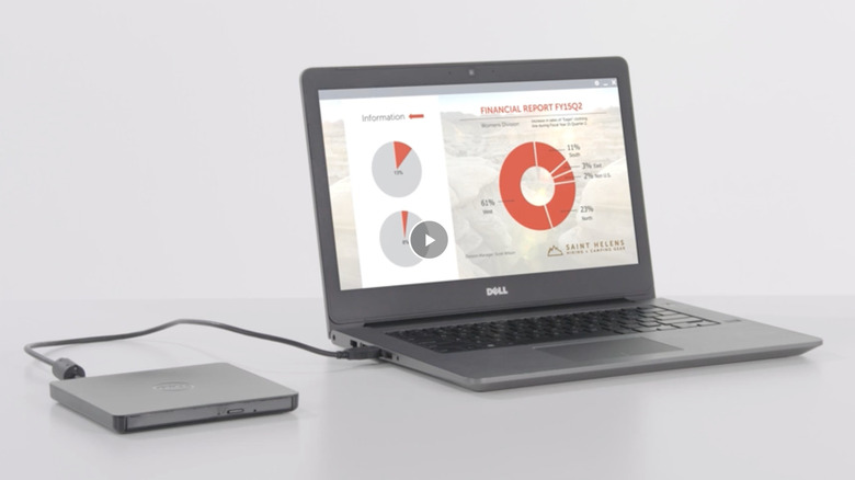 A Dell CD drive plugged into a laptop displaying a presentation