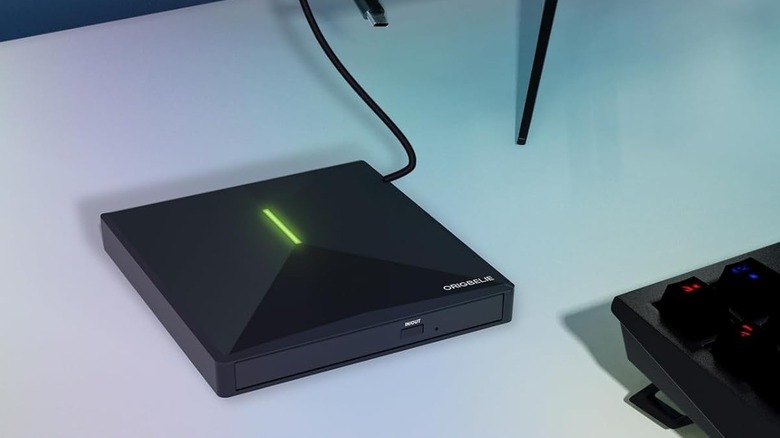 The Origbelie DVD drive, its green LED glowing, connected to a computer