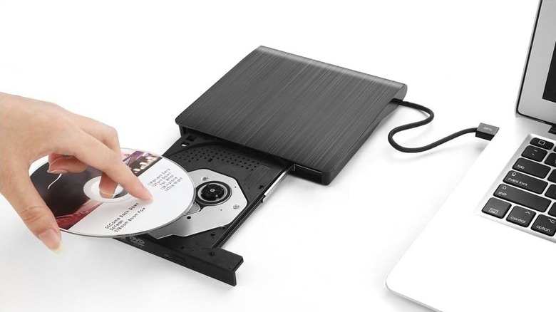 A person inserting a CD inside the Roofull external CD drive