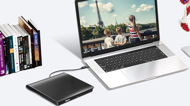 Ziweo external CD DVD drive connected to a laptop with books in the background