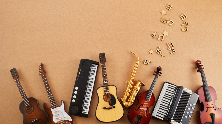 Guitars, keyboards, saxophones and other instruments arranged in an arc and photographed from above