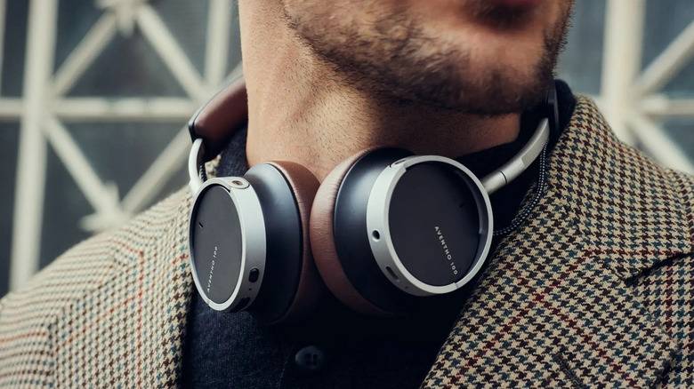 A pair of Beyerdynamic Aventho 100 headphones around the neck of a person