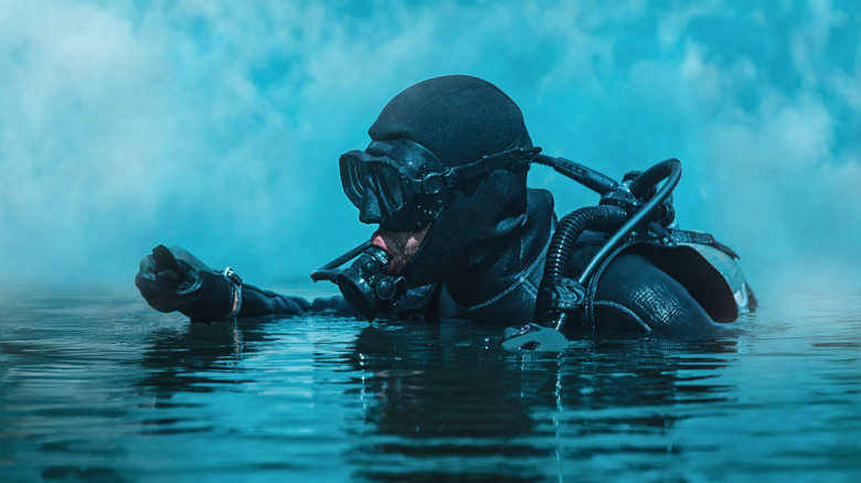 Navy SEAL with knife coming out of water
