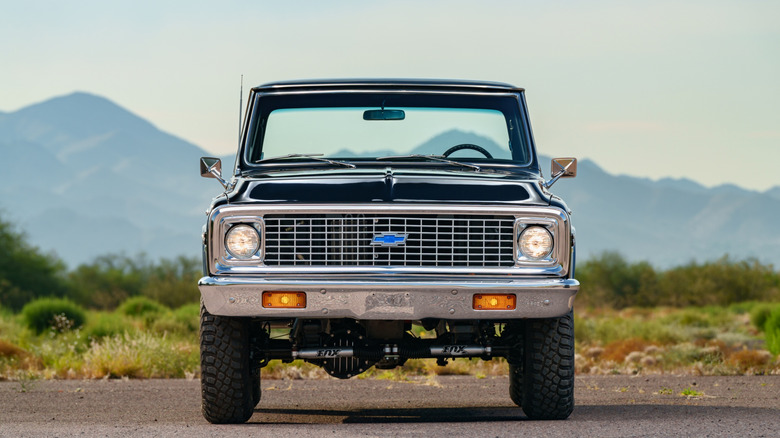 A green Chevy K10 as seen head on