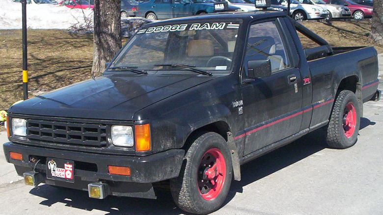 A black Dodge Ram parked on a suburbian street