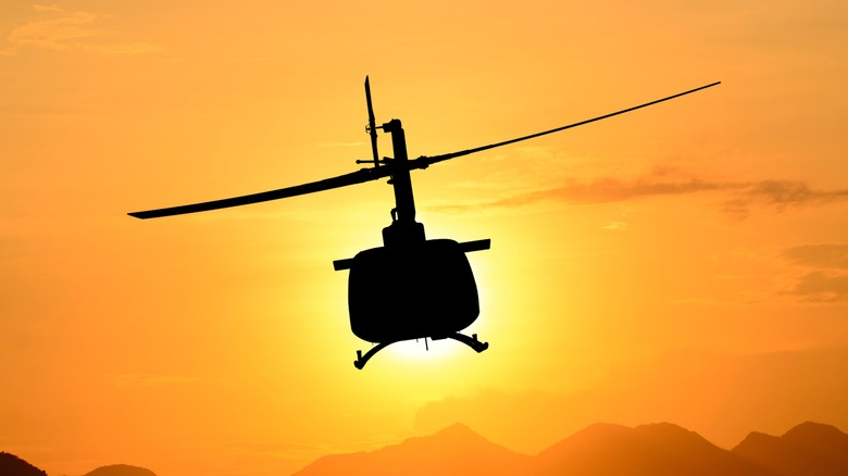 A Bell UH-1 silhouette in midflight.
