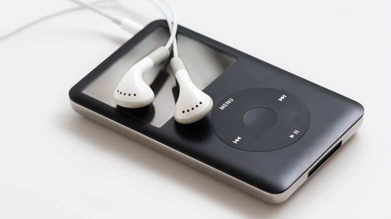 A close-up of the iPod Classic with wired earbuds.