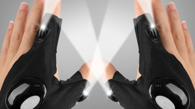 Set of hands wearing partial gloves with attached LED lights