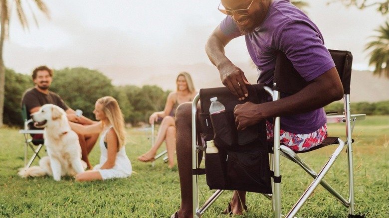 man sitting in Picnic Time camping chair