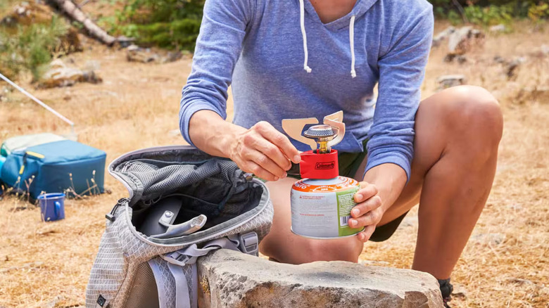 Woman using a camping stove outdoors
