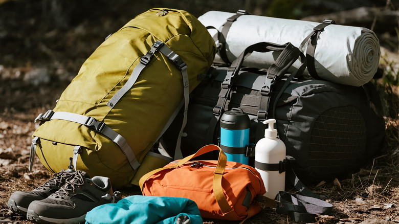 A set of camping gear all packed up and placed on the ground