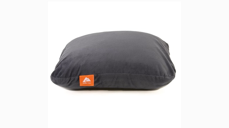 A grey camping pillow against white background