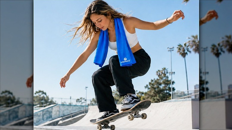 Woman skating in an outdoor arena with a cooling towel around her neck.