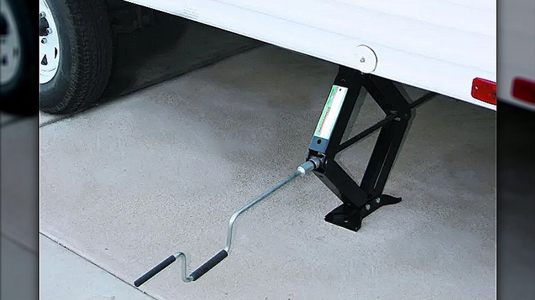 A RV Stabilizer placed underneath a white RV.