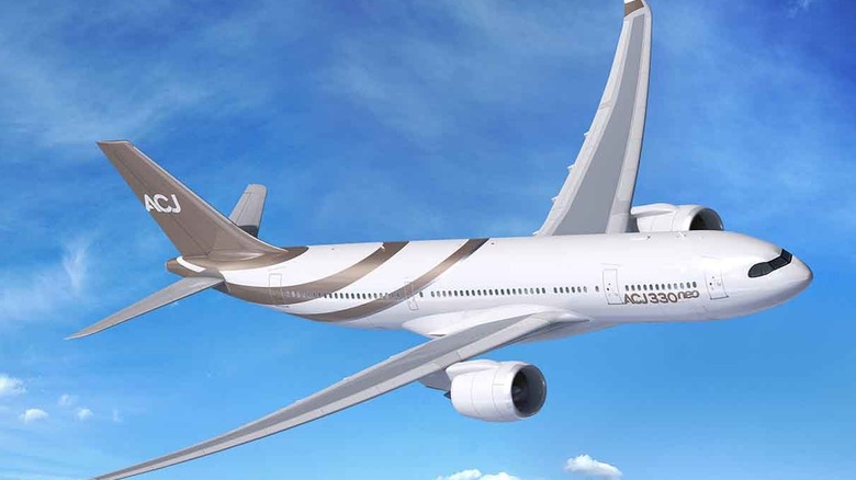 A white Airbus A330-800 Neo private jet from Airbus' corporate jets division taking a steep bank over cloud cover in day time.