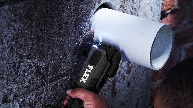 Person using Flex oscillating multi-tool.
