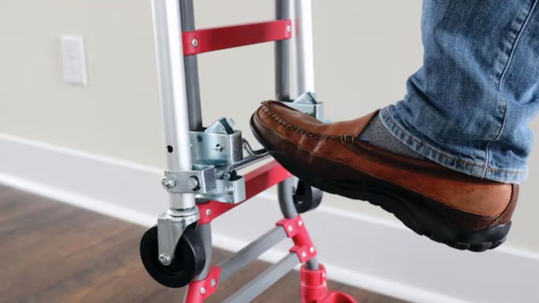 Person using Milwaukee convertible hand truck with a foot.