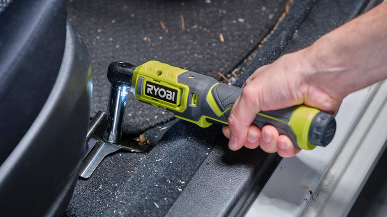 The 3/8-inch Light Duty Ratchet by Ryobi used in a car.