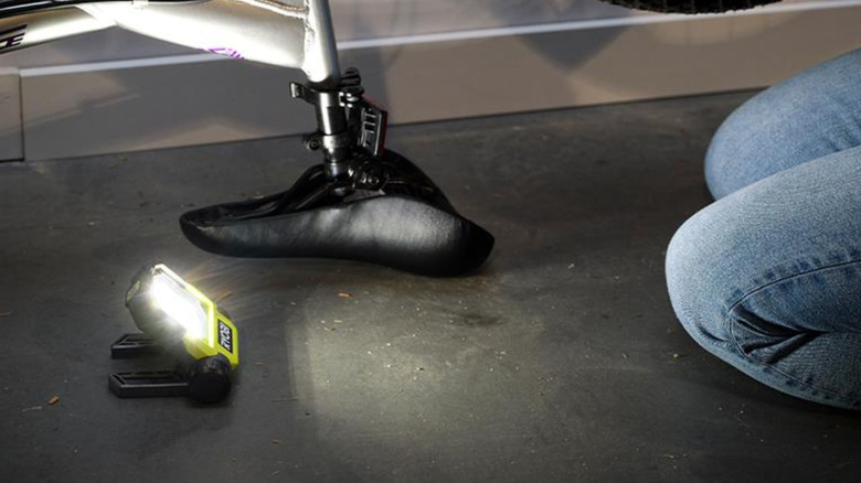 The LED Flip Light on the floor next to a bycicle.