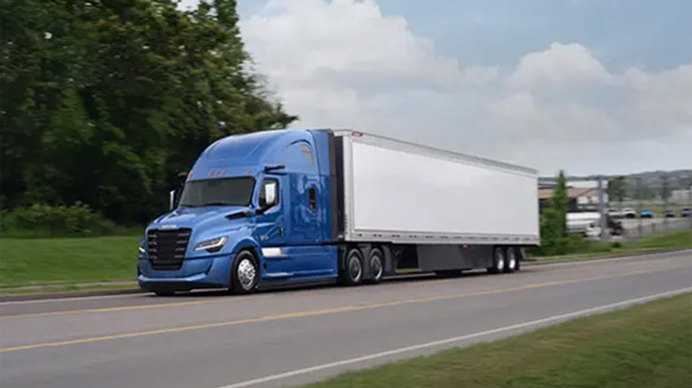A Freightliner Cascadia semi driving on a road