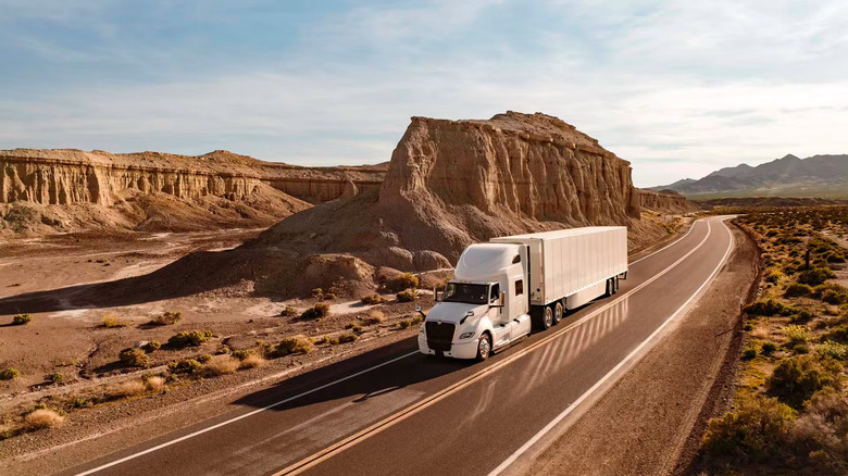 An International LT-series semi-truck driving on a mountain road